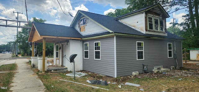 view of property exterior featuring a shingled roof