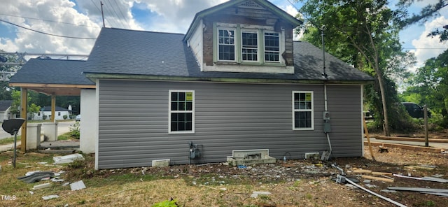 view of property exterior with roof with shingles