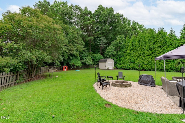 533 E Maple Ave, Holly Springs, NC 27540 - fenced backyard with a gazebo, a storage shed, and an outdoor living space with a fire pit