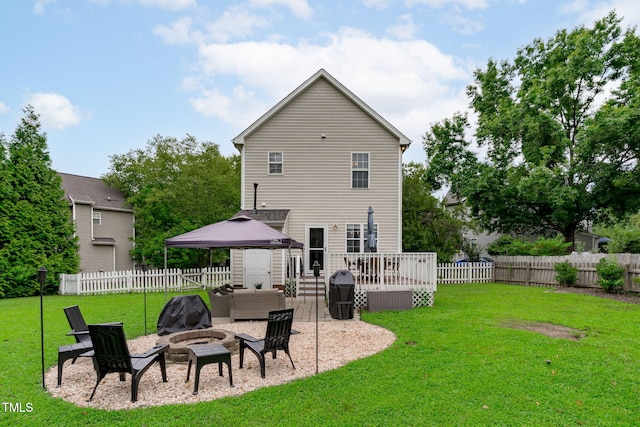 533 E Maple Ave, Holly Springs, NC 27540 - back of house with a fire pit, a gazebo, a deck, and a fenced backyard