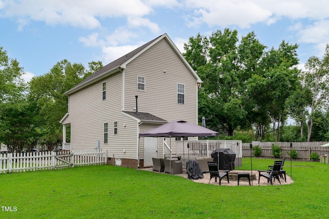 533 E Maple Ave, Holly Springs, NC 27540 - rear view of property featuring a fenced backyard, an outdoor fire pit, a patio area, and roof with shingles