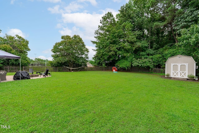533 E Maple Ave, Holly Springs, NC 27540 - fenced backyard featuring a storage unit, a gazebo, and a fire pit