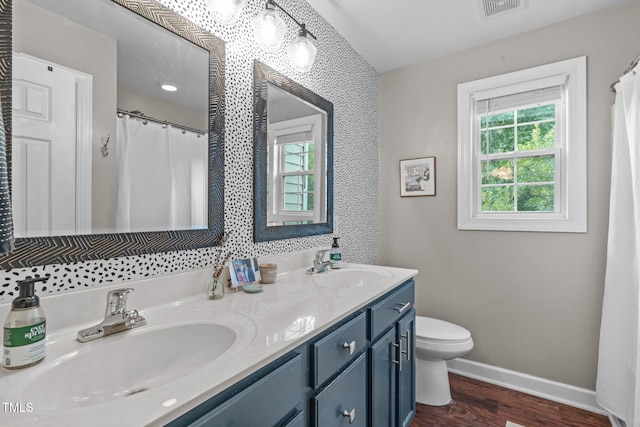 533 E Maple Ave, Holly Springs, NC 27540 - bathroom featuring wood finished floors, double vanity, and curtained shower