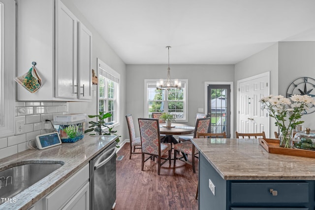 533 E Maple Ave, Holly Springs, NC 27540 - kitchen with dishwasher, dark wood-style floors, a chandelier, hanging light fixtures, and decorative backsplash