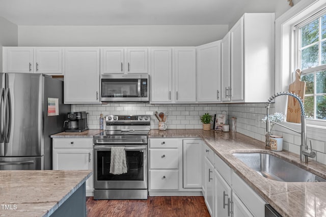 533 E Maple Ave, Holly Springs, NC 27540 - kitchen with stainless steel appliances, white cabinets, dark wood finished floors, and light stone countertops