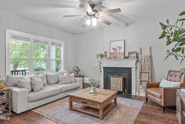533 E Maple Ave, Holly Springs, NC 27540 - living area featuring dark wood-style floors, a ceiling fan, and a fireplace with flush hearth