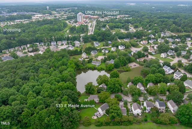 533 E Maple Ave, Holly Springs, NC 27540 - aerial perspective of suburban area featuring a heavily wooded area and a nearby body of water