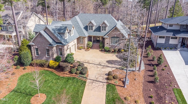 view of front of house with concrete driveway and brick siding