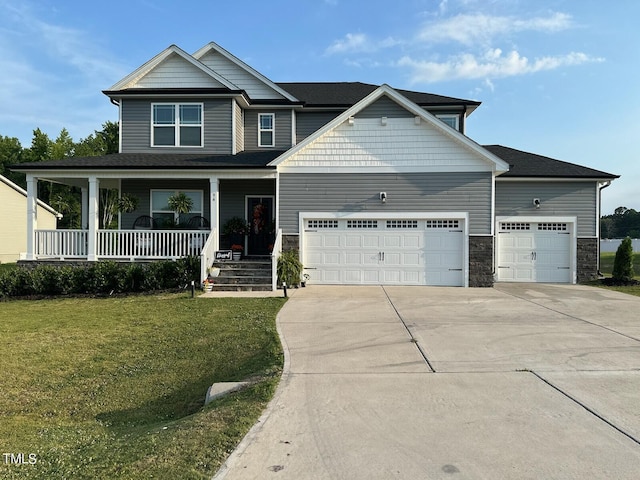 craftsman-style home with an attached garage, covered porch, driveway, stone siding, and a front yard