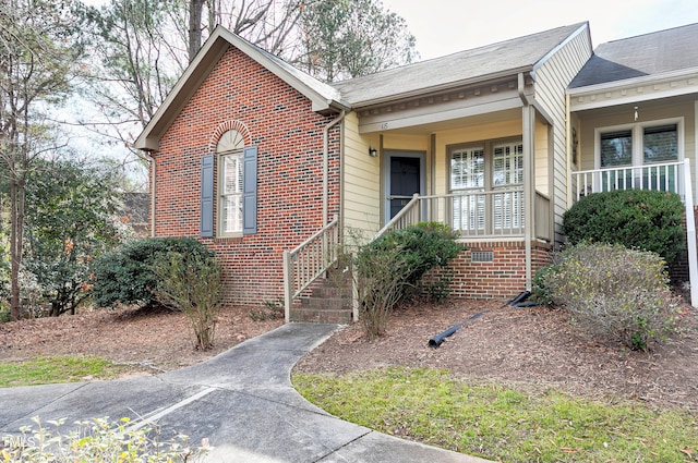 ranch-style home with covered porch and brick siding