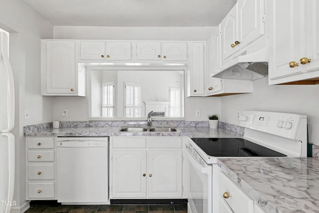 kitchen featuring a textured ceiling, under cabinet range hood, white appliances, a sink, and white cabinets