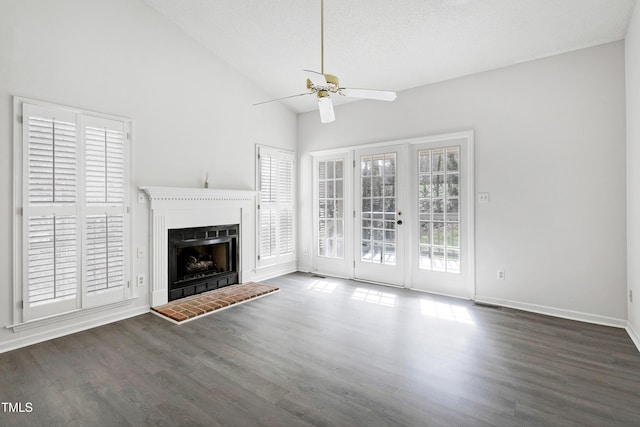 unfurnished living room with a fireplace, wood finished floors, a ceiling fan, and baseboards