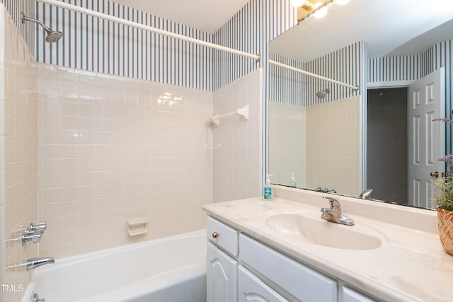 full bath featuring shower / bath combination, vanity, and wallpapered walls