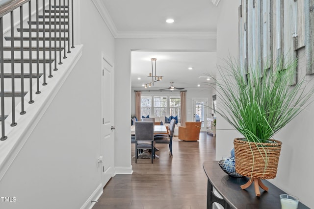 foyer entrance featuring crown molding, recessed lighting, stairway, wood finished floors, and baseboards