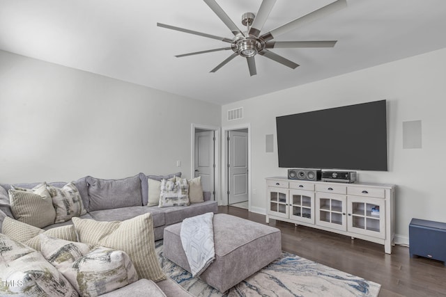 living room featuring visible vents, ceiling fan, baseboards, and wood finished floors