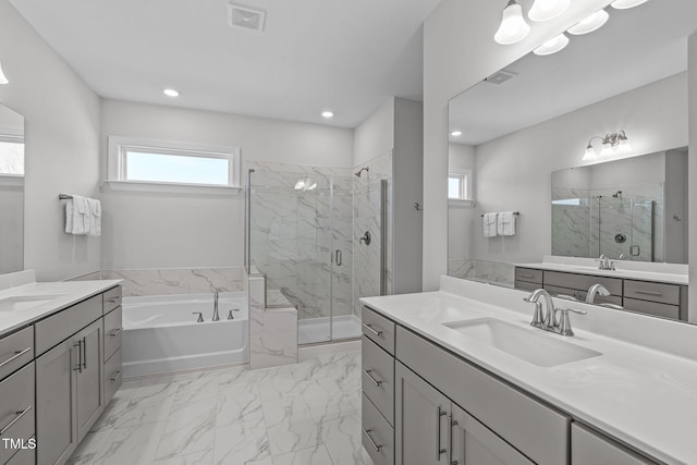 bathroom with a garden tub, a marble finish shower, a sink, and visible vents