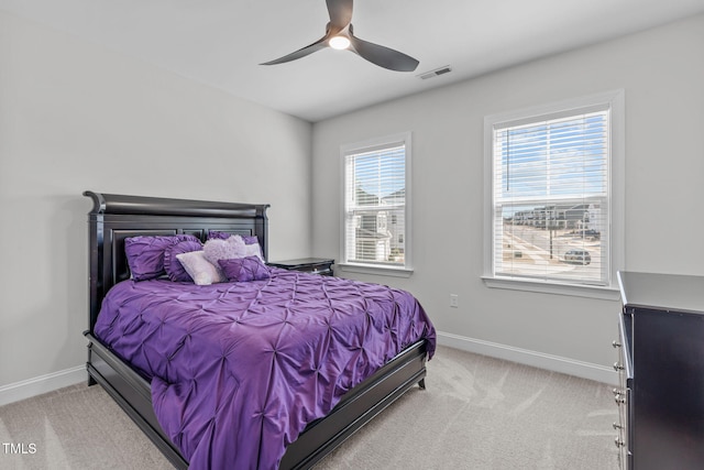 bedroom with light carpet, visible vents, and baseboards