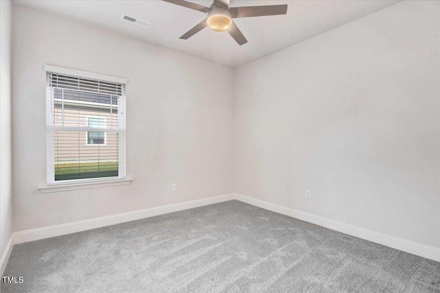 spare room with a ceiling fan, baseboards, visible vents, and carpet flooring