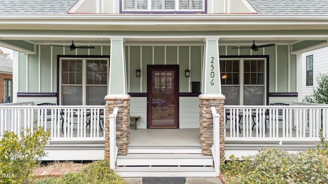 property entrance featuring ceiling fan, a shingled roof, stone siding, and a porch