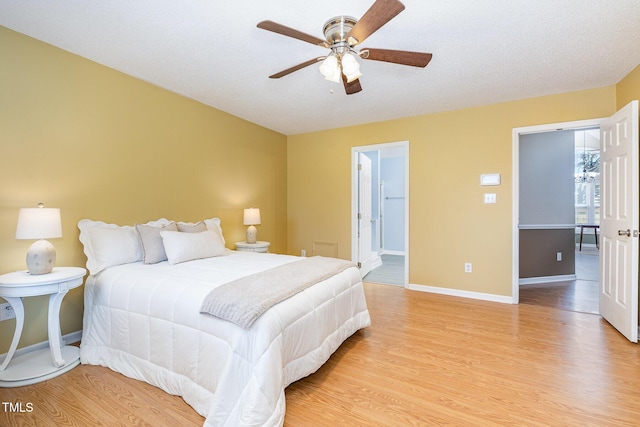 bedroom featuring baseboards, a ceiling fan, and light wood-style floors