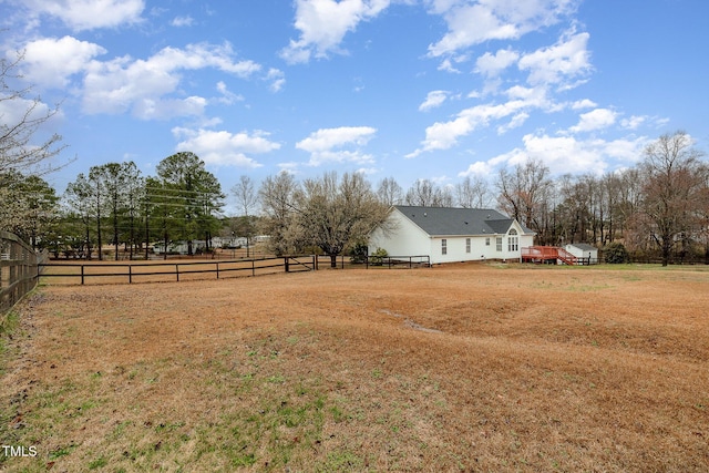 view of yard featuring a rural view and fence