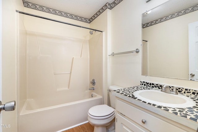 bathroom with shower / bath combination, toilet, a textured ceiling, vanity, and wood finished floors