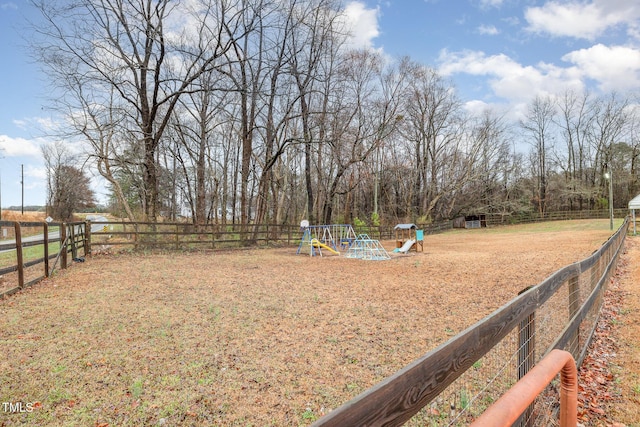 view of yard with fence and a playground