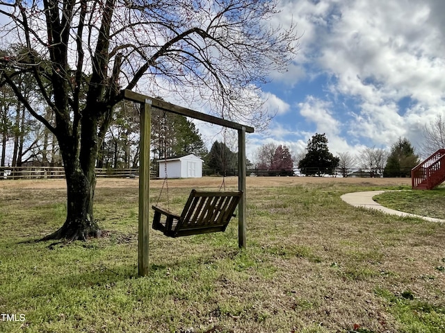 view of yard with fence and an outdoor structure