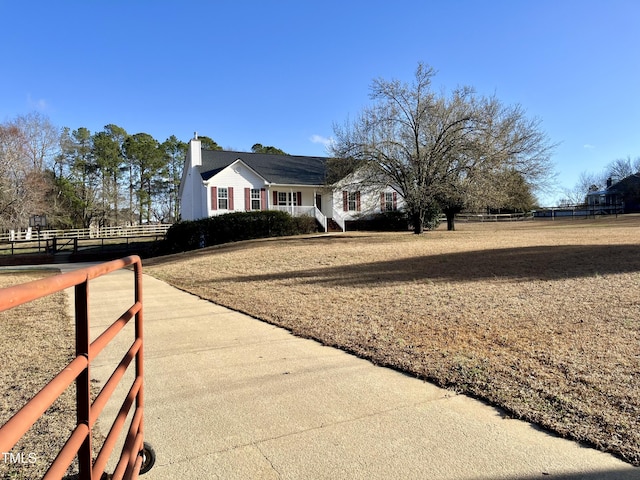 view of property exterior featuring a chimney and fence