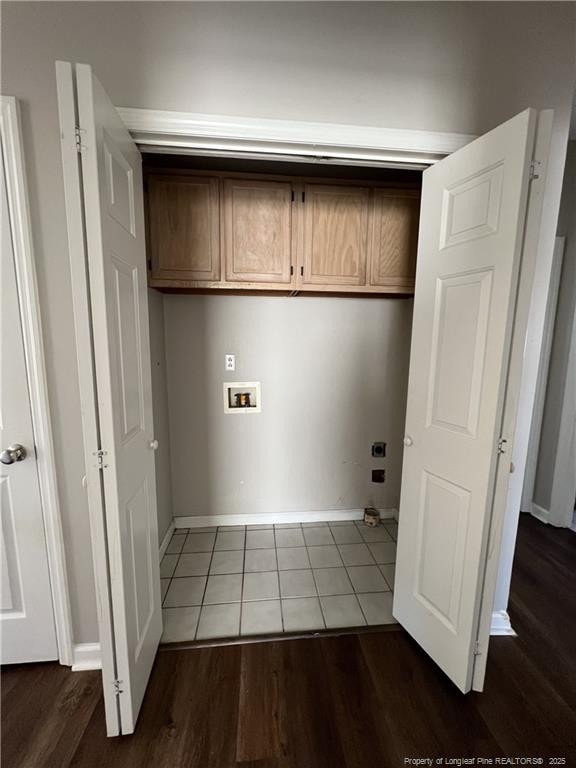 laundry area featuring hookup for a washing machine, cabinet space, baseboards, and dark wood-style floors