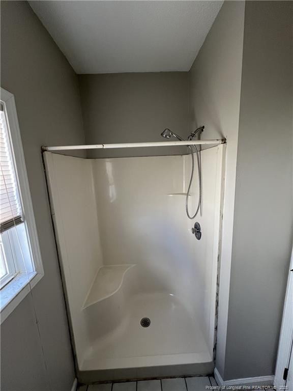 full bath featuring a shower stall