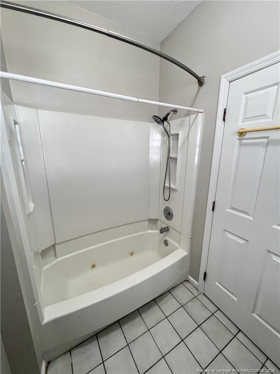 bathroom with tile patterned flooring, a combined bath / shower with jetted tub, and a textured ceiling