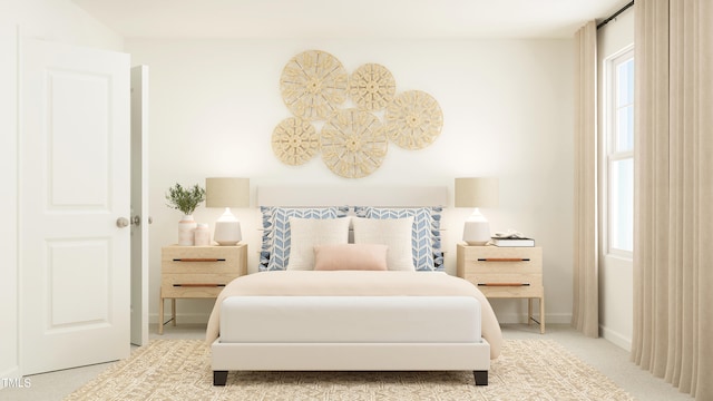 bedroom with baseboards and light colored carpet