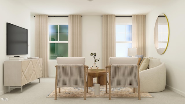 living area featuring carpet floors and baseboards