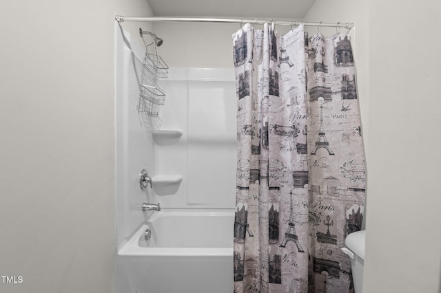 bathroom featuring toilet and shower / tub combo with curtain