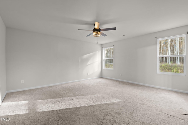 empty room featuring carpet flooring, ceiling fan, and baseboards