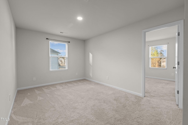 unfurnished room with carpet and baseboards