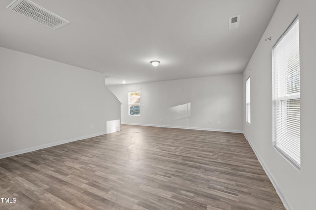 interior space featuring baseboards, visible vents, and wood finished floors