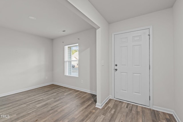 foyer with baseboards and wood finished floors