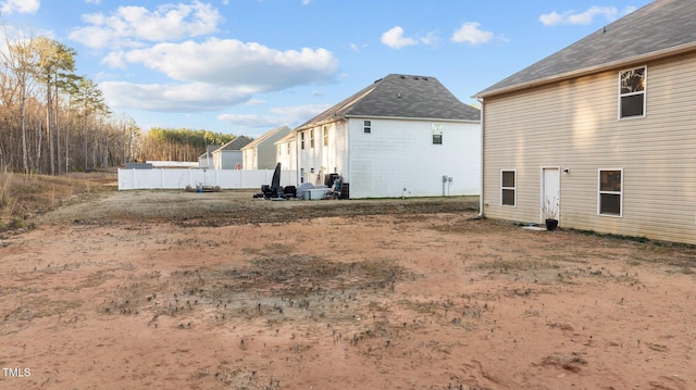 rear view of house featuring fence