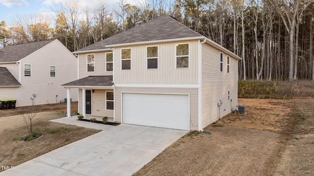 view of front of property featuring driveway, a garage, and central AC unit