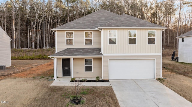 view of front facade featuring a garage, concrete driveway, a shingled roof, and central AC unit