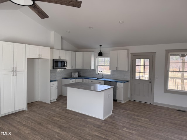 kitchen featuring stainless steel appliances, a center island, and white cabinets