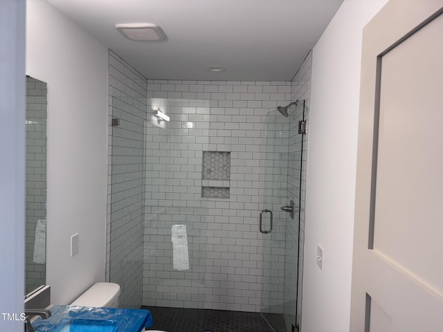 full bath featuring toilet, a shower stall, and vanity