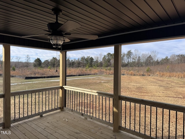 wooden deck featuring ceiling fan and a rural view