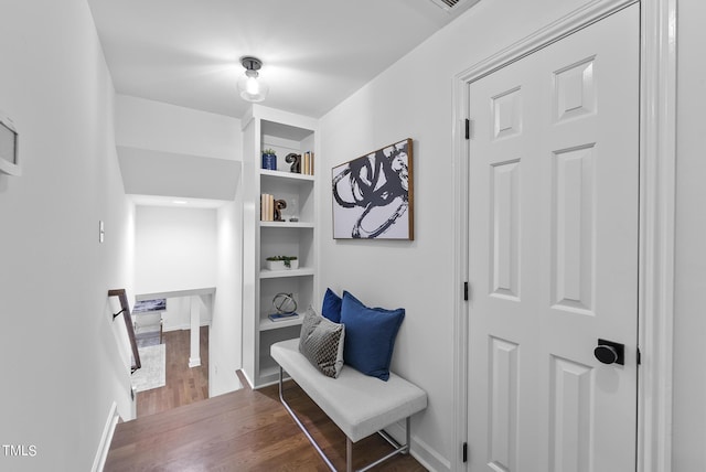 mudroom with baseboards, built in features, and dark wood finished floors