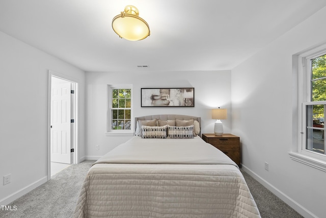 bedroom featuring carpet floors, baseboards, and visible vents