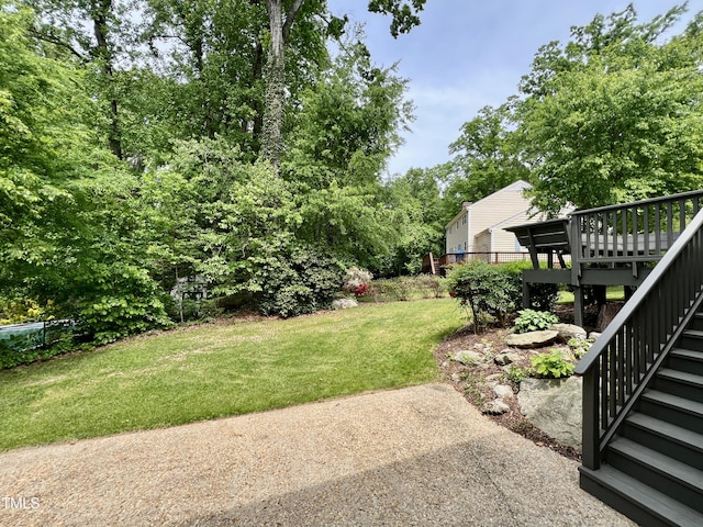 view of yard with stairs and a deck