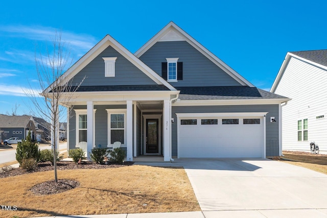 view of front of house with a shingled roof, covered porch, driveway, and an attached garage