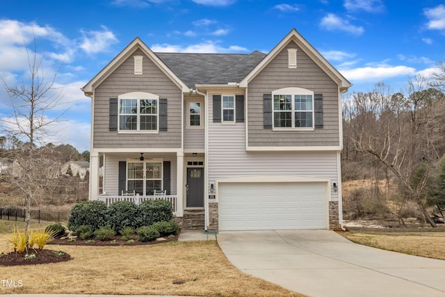 view of front facade featuring a garage, concrete driveway, a porch, and stone siding